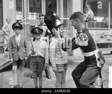 Prove generali per la NATO Tappoep ad Arnhem, ragazzo può calzare cappello di granatiere Data: 11 Luglio 1960 luogo: Arnhem Parole Chiave: Headgear, bambini, militare, tapies : Bilsen, Joop van/Anefo Foto Stock