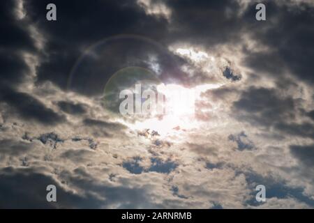 La luce del sole attraverso le spesse nubi scure Foto Stock