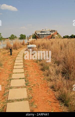 Torna al museo principale della culla Del Genere Umano dal sentiero in pietra in veld, Maropeng, Gauteng, Sud Africa. Foto Stock