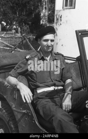 Sergente Maggiore polizia militare KNIL pone in jeep. Sul parabrezza, il segno premere. Dietro di lui ci sono dei roadblock mobili che indicano una caserma come luogo Data: 1947/01/01 luogo: Indonesia, Indie orientali olandesi Foto Stock