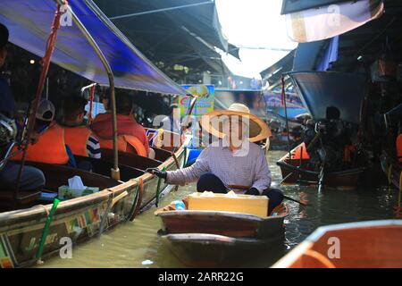Bangkok/Thailandia - 29 dicembre 2019: Il fornitore locale vende il prodotto sul fiume nel mercato galleggiante di Damnoen Saduak. Il mercato galleggiante è uno di vista Foto Stock