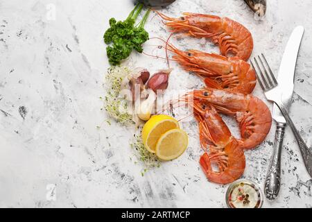 Gustosi gamberi con limone e aglio su sfondo chiaro Foto Stock