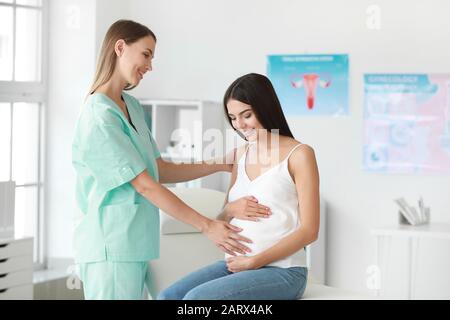 Ginecologo femmina lavora con la donna incinta in clinica Foto Stock