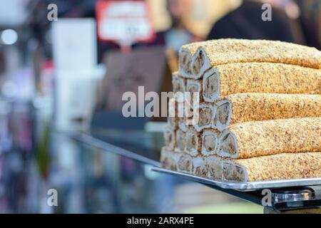 Marshmallow bianco con crema al pistacchio da vicino. Presa dal bordo. Sul vassoio situato sul piano di lavoro del vetro. Foto Stock