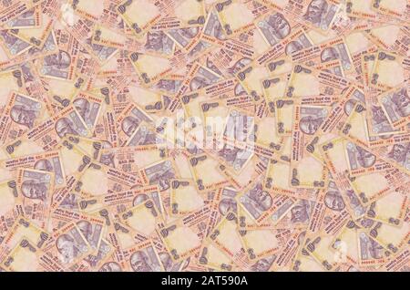 Il Mahatma Gandhi volto sulla banca indiana nota dieci rupie. 10 rupie valuta nazionale dell'India INR. Il denaro Orange bill close up Foto Stock