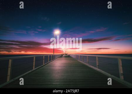 Tramonto su Grange jetty, Adelaide, South Australia Foto Stock