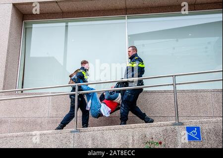 Un attivista XR arrestato dalla polizia durante la campagna.Circa venti attivisti del gruppo Extinction Rebellion si sono presentati alla sede della Shell nell'ambito della campagna Shell deve cadere, che si svolge per tutta la settimana in tutto il paese. Alcuni degli attivisti della ribellione d'estinzione si sono incollati alle finestre e alle porte di cristallo dell'edificio. Dopo aver rifiutato di lasciare il posto, la maggior parte di loro sono stati arrestati dalla polizia. Foto Stock