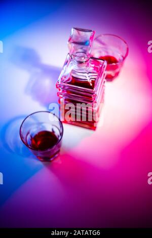 Caraffa quadrata in vetro con liquore e due bicchieri di vetro. Vista dall'alto Foto Stock