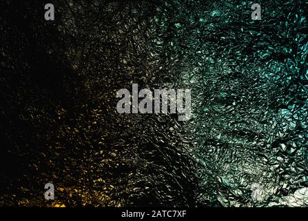 Giallo arancio verde grunge astratto sbriciolato alluminio, titanio lucido foglio nuovo anno, sfondo di Natale Foto Stock