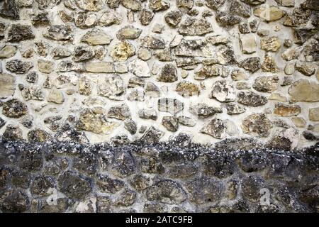 Muro di pietra in strada urbana, di costruzione e di architettura, textures Foto Stock