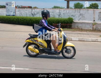 Samut PRAKAN, TAILANDIA, 3 GIUGNO 2019, un giro di un uomo su una moto. Scooter con autista con casco sulla strada della città. Foto Stock