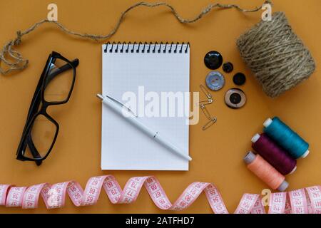 Gruppo di oggetti da cucire adagiati su uno sfondo colorato. Sfondo orizzontale per annuncio o imballaggio Foto Stock