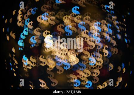 Dollar bokeh luci. Abstract background finanziario con molti simboli di dollaro. Foto Stock