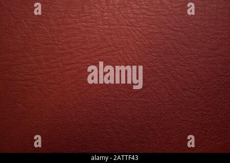 Tessuto di pelle rossa di vino, utile come sfondo per lavori di design Foto Stock