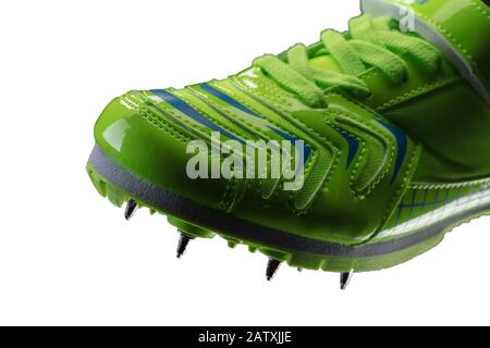 Frammento di una sneaker verde lucida con punte su sfondo bianco. Scarpe sportive. Foto Stock