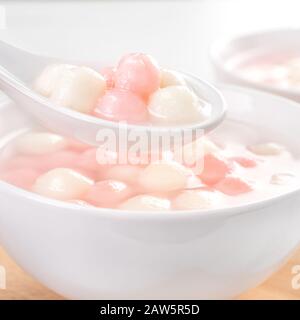 Tang yuan, tangyuan, deliziose palle di riso rosso e bianco in una piccola ciotola. Cibo tradizionale asiatico per le feste per il Festival invernale cinese del Solstice, Foto Stock