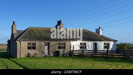 Due semi indipendente vecchio, e recentemente abbandonato Agriturismo fuori dal villaggio rurale di Aberlemno su una chiara mattina inverni. Foto Stock