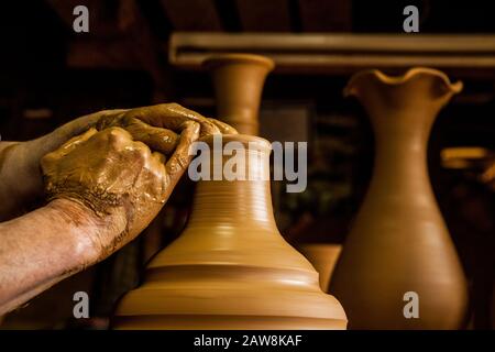 Mani di un vasaio, creando un vasetto per l'orecchio. Produzione di ceramica da argilla. Foto Stock