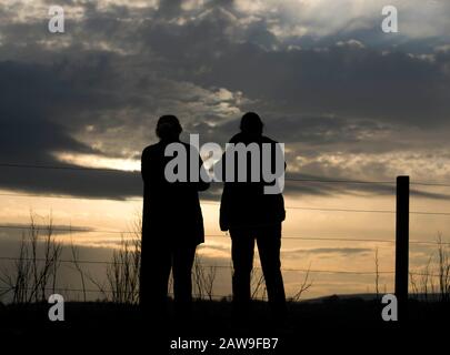 Lochwinnoch, Renfrewshire, Scozia, Regno Unito. 7th Febbraio 2020 I Turisti guardano a sud verso il tramonto sopra Barr Loch a Lochwinnoch. Un avvertimento meteo giallo è stato emesso con forti venti previsti il Sabato pomeriggio e la sera può portare ad un certo disturbo. Ci si aspetta qualche ritardo per viaggiare su strada, in treno e in traghetto, con condizioni peggiorate dalla pioggia battente, dall'acqua di superficie e dal credito spray: Chris McNulty/Alamy Live News Foto Stock