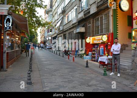 Istanbul, Turchia - Settembre 18th 2019. Un operaio del ristorante attende i clienti su una strada nel quartiere residenziale di Moda di Kadikoy Foto Stock