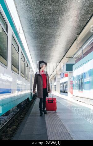 Donna elegante che va per un viaggio d'affari in treno Foto Stock