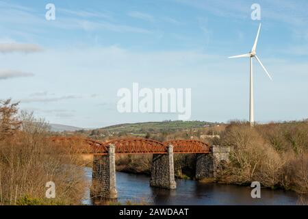 La turbina eolica di Astellas e il vecchio viadotto ferroviario metallico sul fiume Laune a Killorglin, contea di Kerry, Irlanda Foto Stock