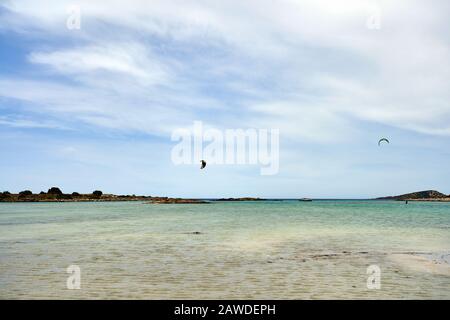 Il kite surfer volare sulla superficie dell'acqua del Mediterraneo. Incredibile spiaggia di Elafonissi nell'isola di Creta, Grecia. Scenic Spot è noto per la sua p Foto Stock