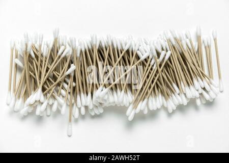 vista dall'alto una pila di auricolari biodegradabili realizzati con materiali naturali su sfondo bianco, concetto di zero sprechi Foto Stock