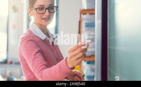 Insegnante a scuola che scrive le cose su una lavagna nera Foto Stock