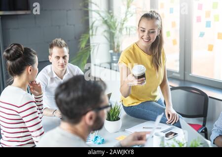 I giovani uomini di affari riunione in ufficio e discutendo insieme un nuovo progetto di avvio. Foto Stock