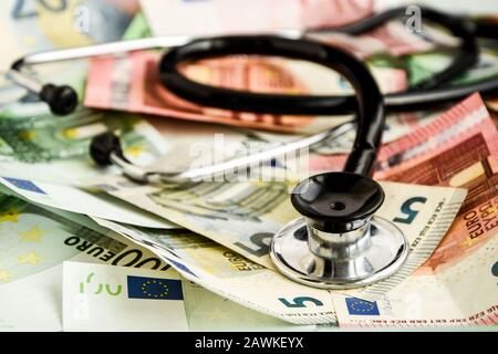 Stetoscopio e banconote in euro, Medical Cost Concept - Stetoscopio su banconote in euro Foto Stock