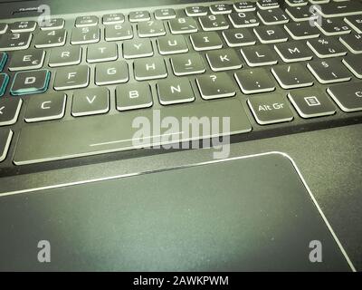 Moderna tastiera per giochi per laptop con retroilluminazione LED blu e touchpad Foto Stock