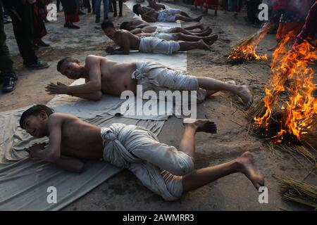 Bhaktapur, Nepal. 09th Feb, 2020. I devoti indù nepalesi che rotolano sul terreno durante l'ultimo giorno del festival di Narayan di Madhav o del festival di Katha di Swasthani Brata a Bhaktapur, in Nepal il 9 febbraio 2020. I devoti vanno in pellegrinaggio a vari templi, svolgono rituali religiosi, fanno un bagno santo nei fiumi e veloci per un mese, soprattutto tra le donne che credono che il digiuno aiuti nel benessere della loro famiglia o nel farli un buon marito. (Foto Di Subash Shrestha/Pacific Press) Credit: Pacific Press Agency/Alamy Live News Foto Stock