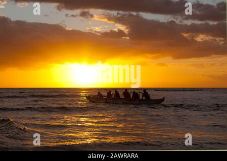 Outrigger canoa padders a Cove Park, Kihei, Hawaii al tramonto. Foto Stock