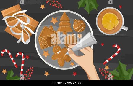 Mani di donna che disegnano sui biscotti di pan di zenzero. Regali, decorazioni di bacche e tazza di caffè con fetta di arancia su tavolo di legno. Vettore vacanza Illustrazione Vettoriale