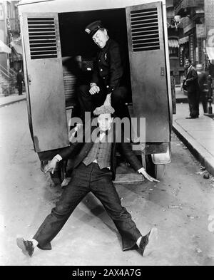 1928 , USA : l'attore e regista americano del cinema muto BUSTER KEATON ( 1895 - 1966 ) , in CAMERAMAN ( 1928 ) - SILENT MOVIE - CINEMA MUTO - ritratto - ritratto - registrazione filmato - attore - comico - scarpe - cappello - CAPPELLO - ANNI TRENTA - 30 - '30 - cellulare della polizia - Poliziotto - Poliziotto - arretto - papillon - cravatta - cravatta - cravatta prua - Gilet - panciotto ---- ARCHIVIO GBB Foto Stock