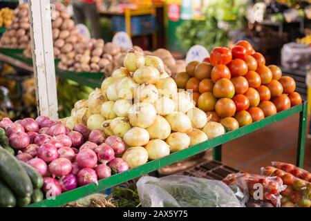 mucchio di pomodori e cipolla rossa e bianca nel mercato, piano generale Foto Stock