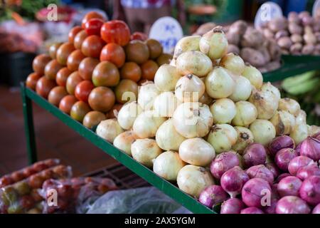 mucchio di pomodori e cipolla rossa e bianca nel mercato, piano generale Foto Stock