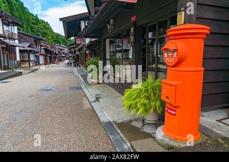 Narai-Juku, Giappone - 6 settembre 2016: Posta post-box arancione brillante in via Narai. Valle di Kiso Foto Stock