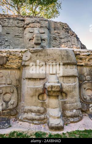 Rilievi maschera stucco a Cerro Maya, rovine sulla baia di Corozal, costa del Mar dei Caraibi, vicino al villaggio di Copper Bank nella penisola di Cerros, Belize Foto Stock