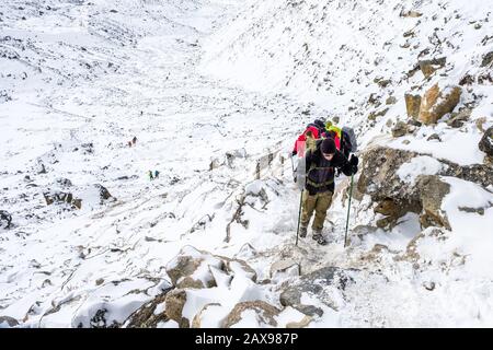 Gruppo di escursionisti sul campo base Everest Trek in inverno neve, Nepal Himalaya Foto Stock