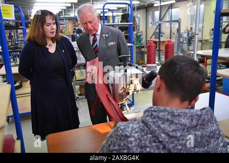 Il Principe di Galles, insieme al fondatore Julie Deane OBE (a sinistra), durante una visita alla Cambridge Satchel Company, Leicester. Foto Stock