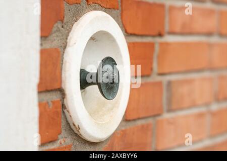 Primo piano di un vecchio campanello su un muro di mattoni a Venezia (Italia) Foto Stock