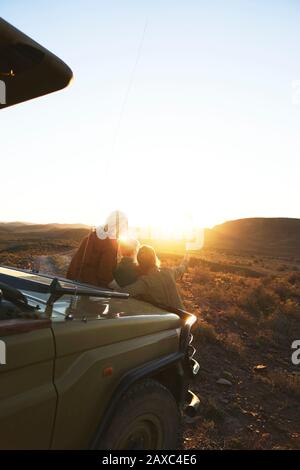 Amici durante il safari godendosi l'alba panoramica Sud Africa Foto Stock