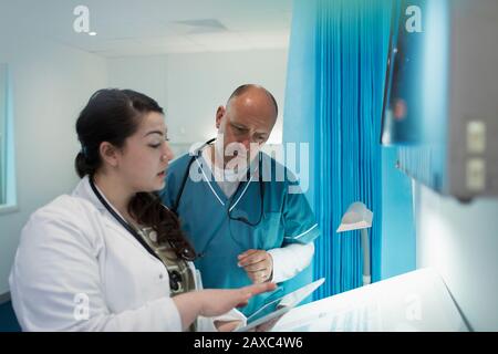 Medici che utilizzano un tablet digitale nella sala ospedaliera Foto Stock