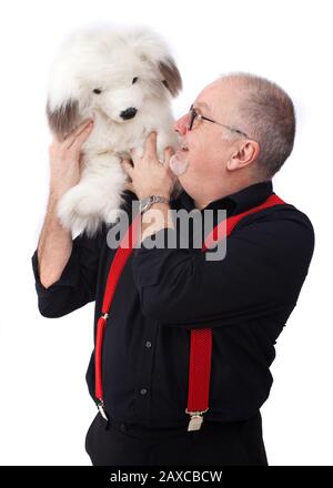 Un ventriloquist con un cane come un puppet Foto Stock