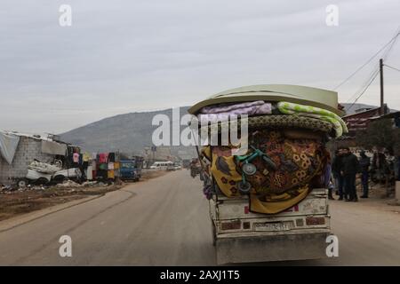 11 Febbraio 2020: Aleppo, Siria. 11 Febbraio 2020. Gli sfollati siriani viaggiano dalla campagna occidentale di Aleppo verso la città di Afro, vicino al confine turco, mentre le forze governative siriane sostenute dal loro alleato russo premono la loro campagna nel nord-ovest della Siria. L'attuale intensificazione della campagna militare per sradicare le ultime roccaforti ribelli nella provincia di Idlib e nella campagna di Aleppo ha causato un grande esodo di civili e, secondo le agenzie di soccorso, più di 700, Lo scorso dicembre sono state sfollate le famiglie in quello che le Nazioni Unite definiscono il peggior sfollamento del paese Foto Stock