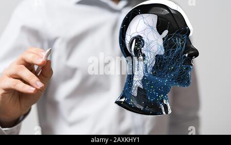 Persona che tocca una proiezione digitale di una testa umana - concetto creativo di pianificazione aziendale Foto Stock