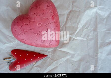 San Valentino, piccolo cuore di fragola con cuore rosa fiorito su sfondo bianco carta avvolgente. Primo piano, posizionare il testo. Foto Stock