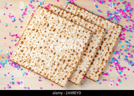 Matzah e confetti sono felici sfondo colorato per la festa della Pasqua Ebraica. Concetto di celebrazione di Pesach. Foto Stock